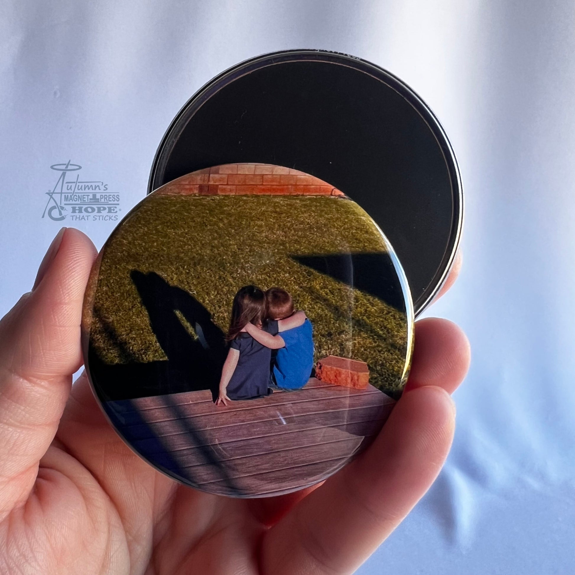 2.5 inch round custom photo magnet showing front photo and magnetic backing