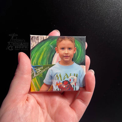 Hand holding a square photo magnet of a young student’s school portrait, celebrating learning, pride, and everyday joy from Autumn’s Magnet Press.