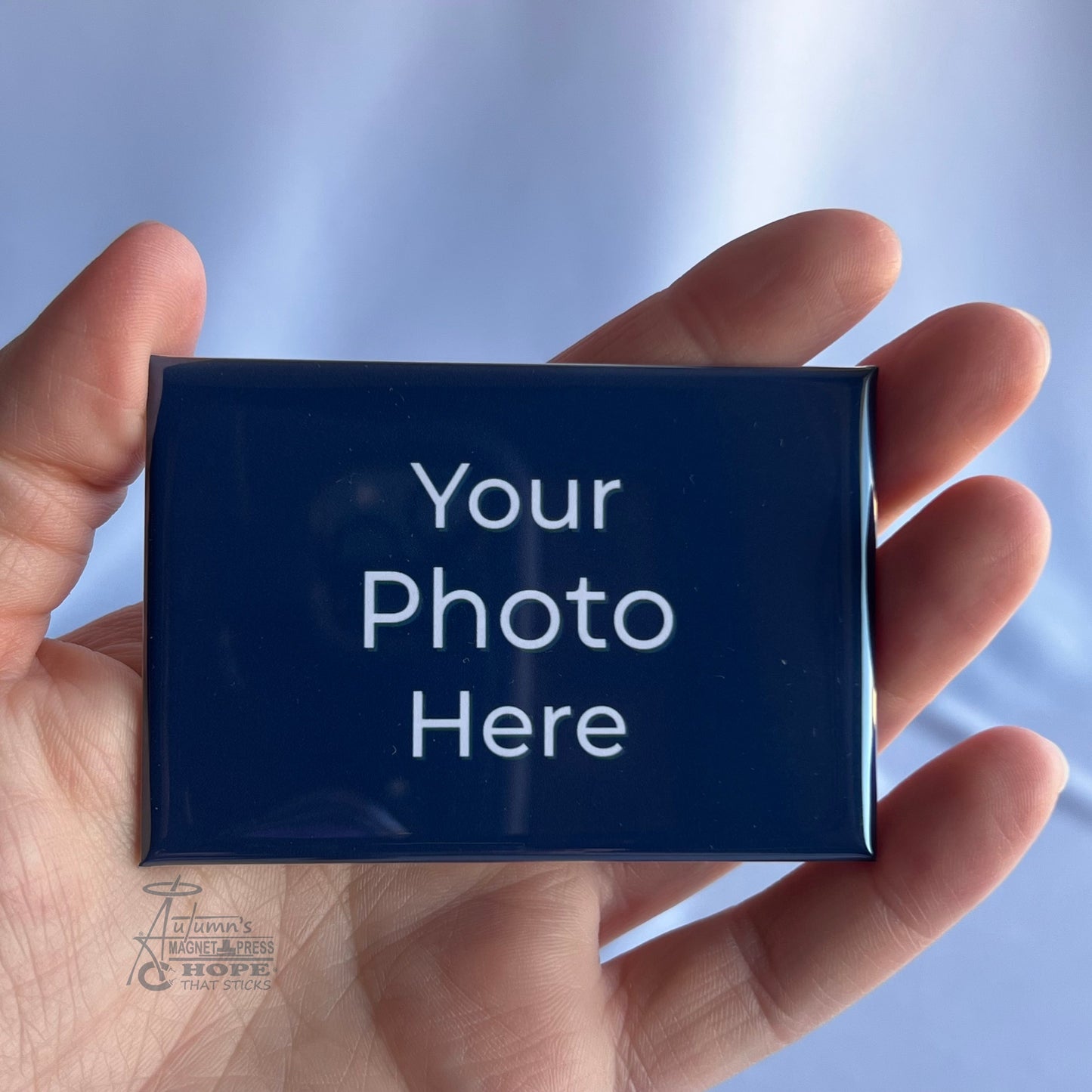 2x3 rectangle custom photo magnet held in hand.
