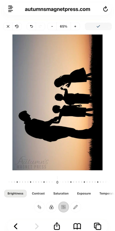 A photo of a family silhouette at sunset, likely sold as a magnet design or art print, shown within a screenshot of a photo editing interface. The design features a mother and two children and a father in black silhouette against a warm orange and yellow sunset gradient.
