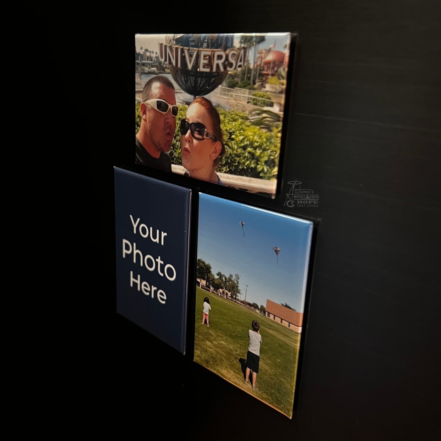 Set of 3 rectangle custom photo magnets with family and travel photos on a dark metal surface