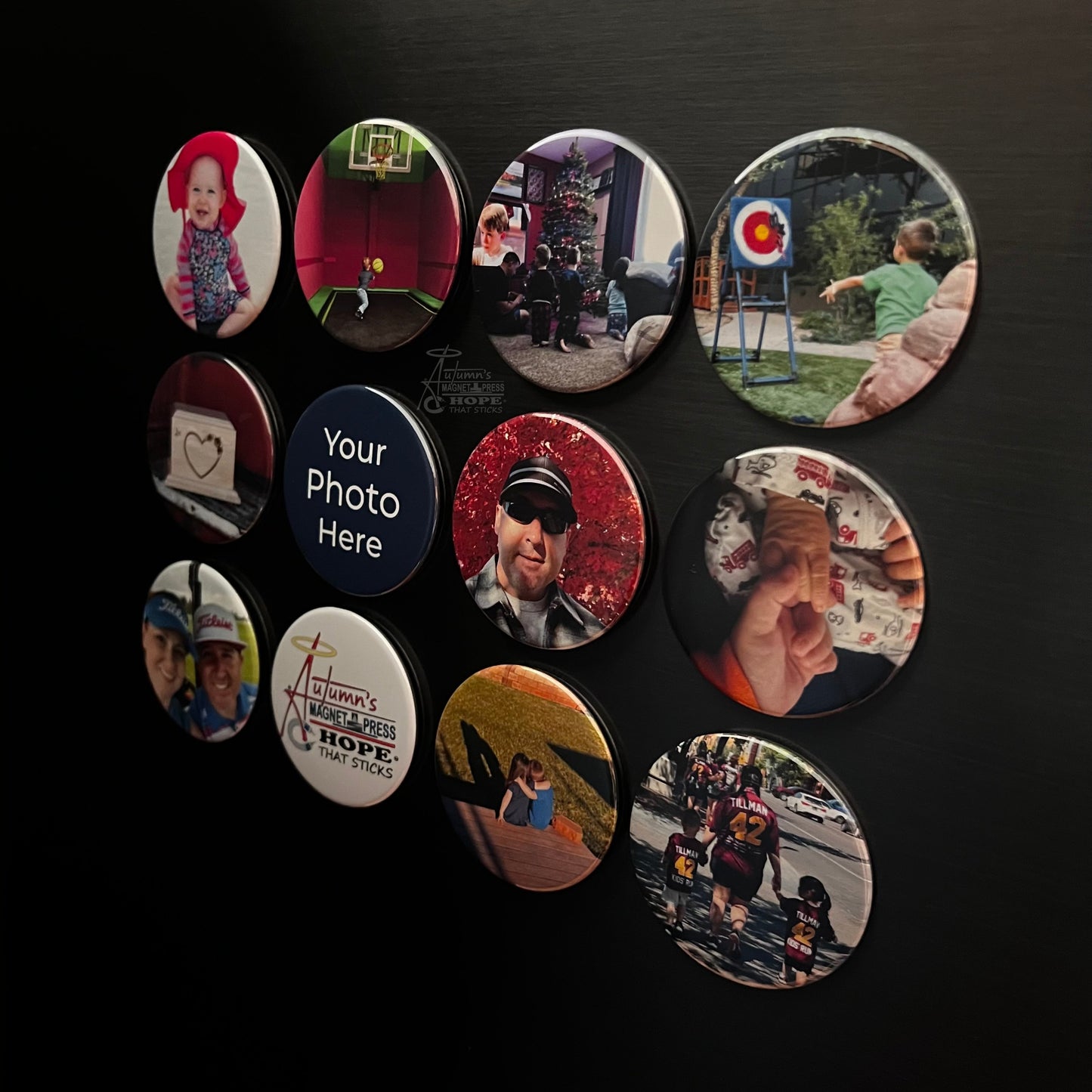 Set of 12 round custom photo magnets with different family photos arranged on a dark metal surface