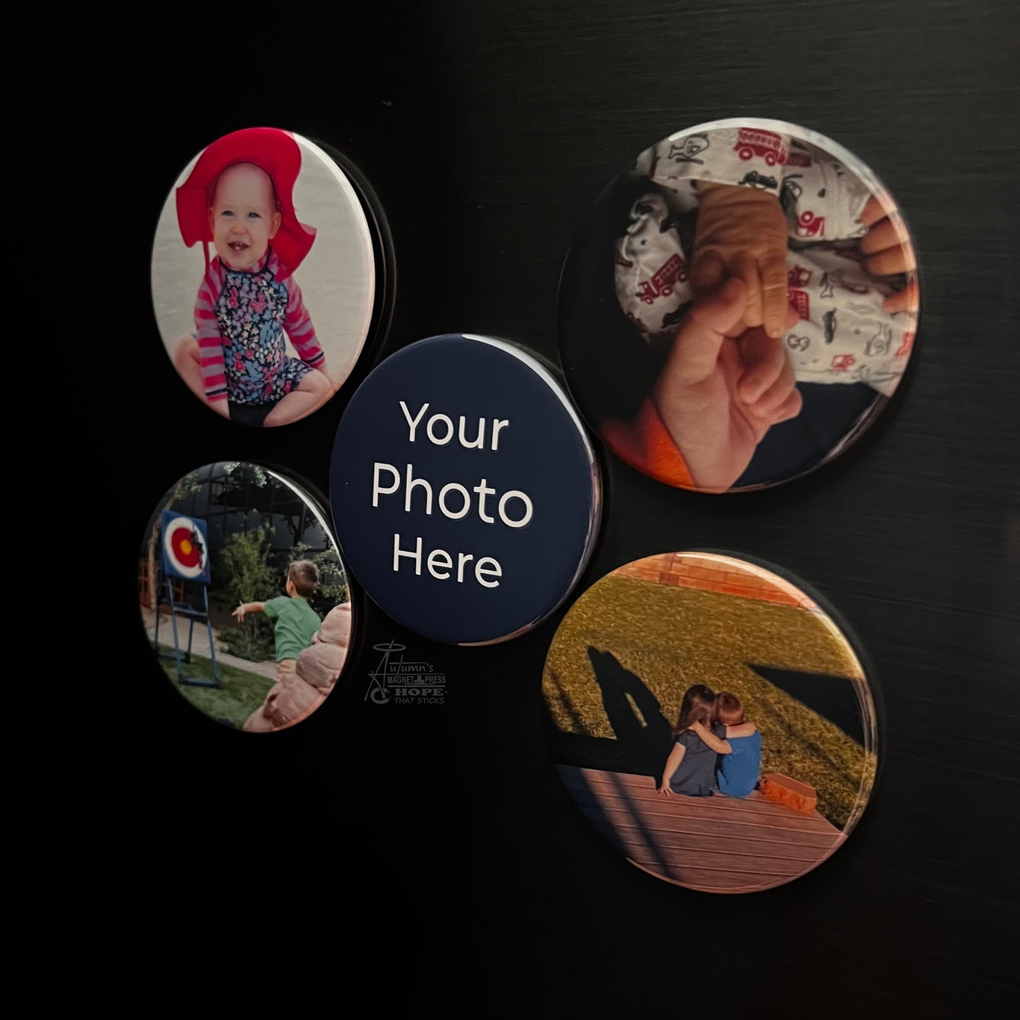 Set of 5 round custom photo magnets showing family and couple photos on a dark metal surface